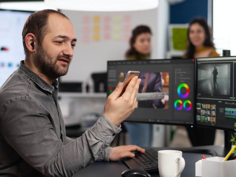 video-editor-discussing-online-with-customer-designer-holding-smartphone-1.jpg